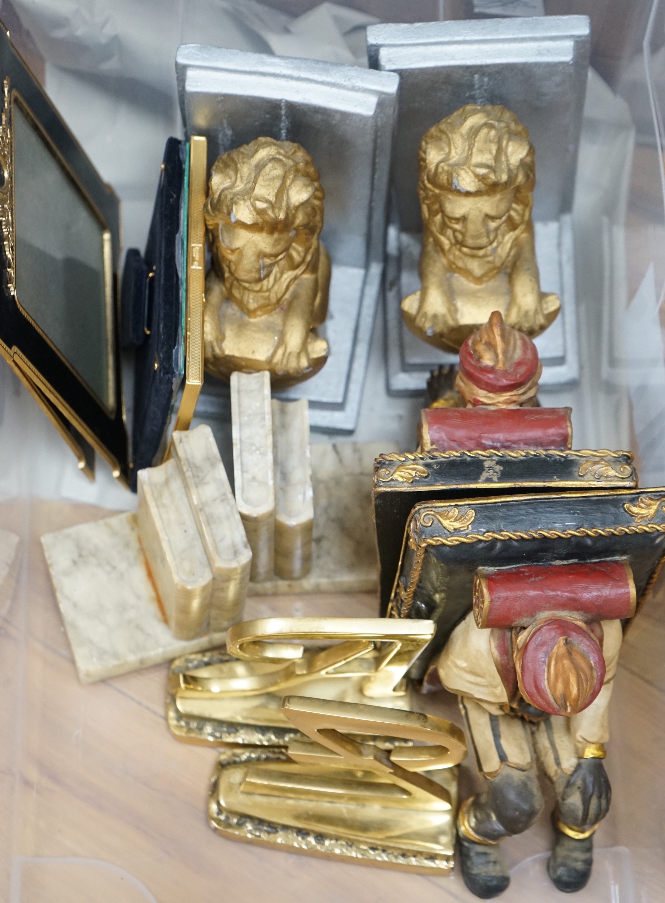 Various pairs of bookends and three photograph frames
